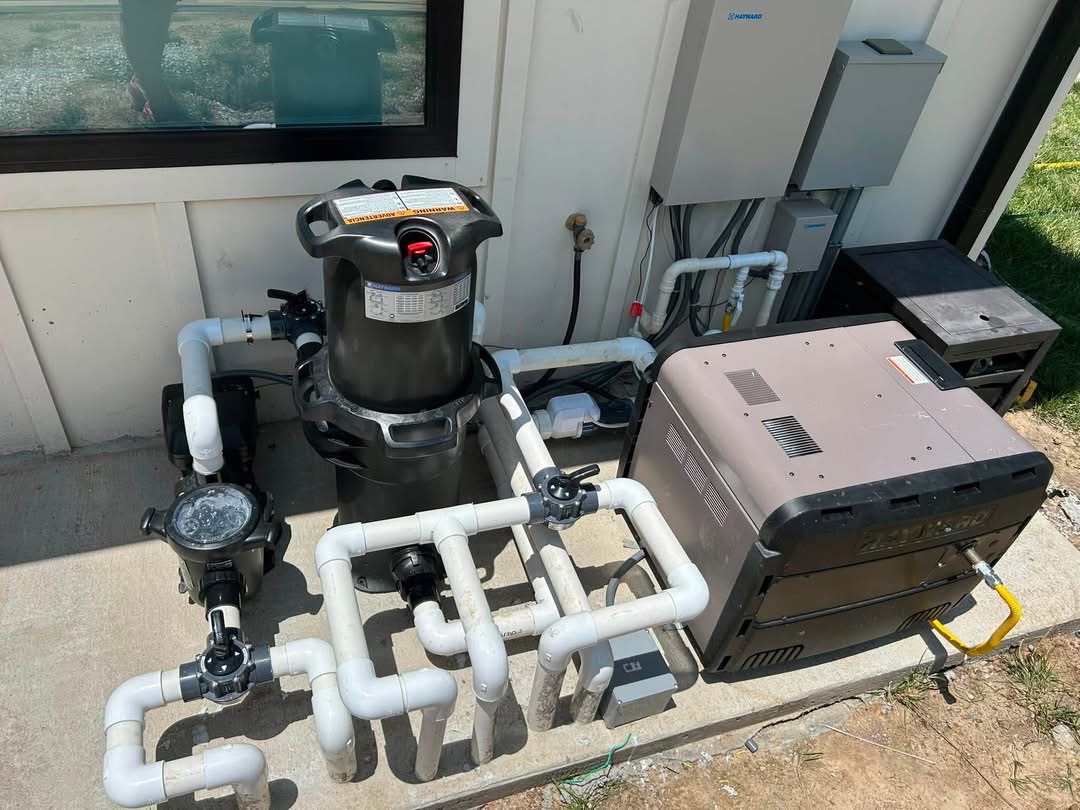 Pool Equipment Plumbing — Pump, filter, and heater manifold plumbed and valved on the pad.