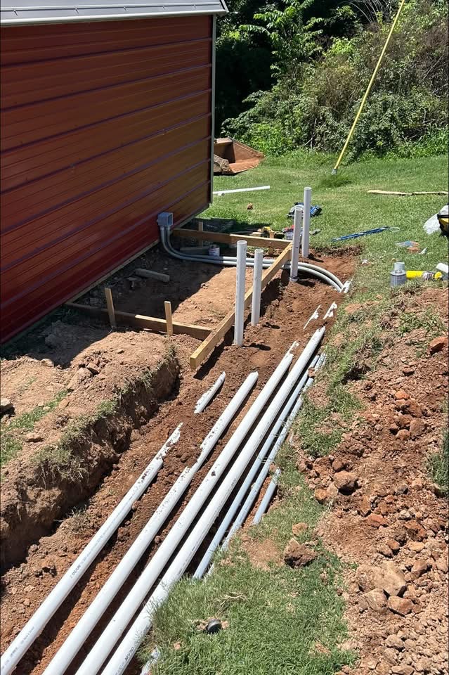 Underground Line Run — New water and drain lines trenched in, with stub ups set at the wall.