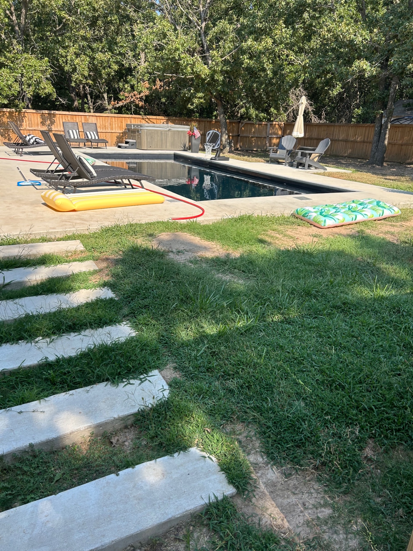 Pool Patio & Stepping Stones — Concrete patio and set stone path leading back to the pool deck.