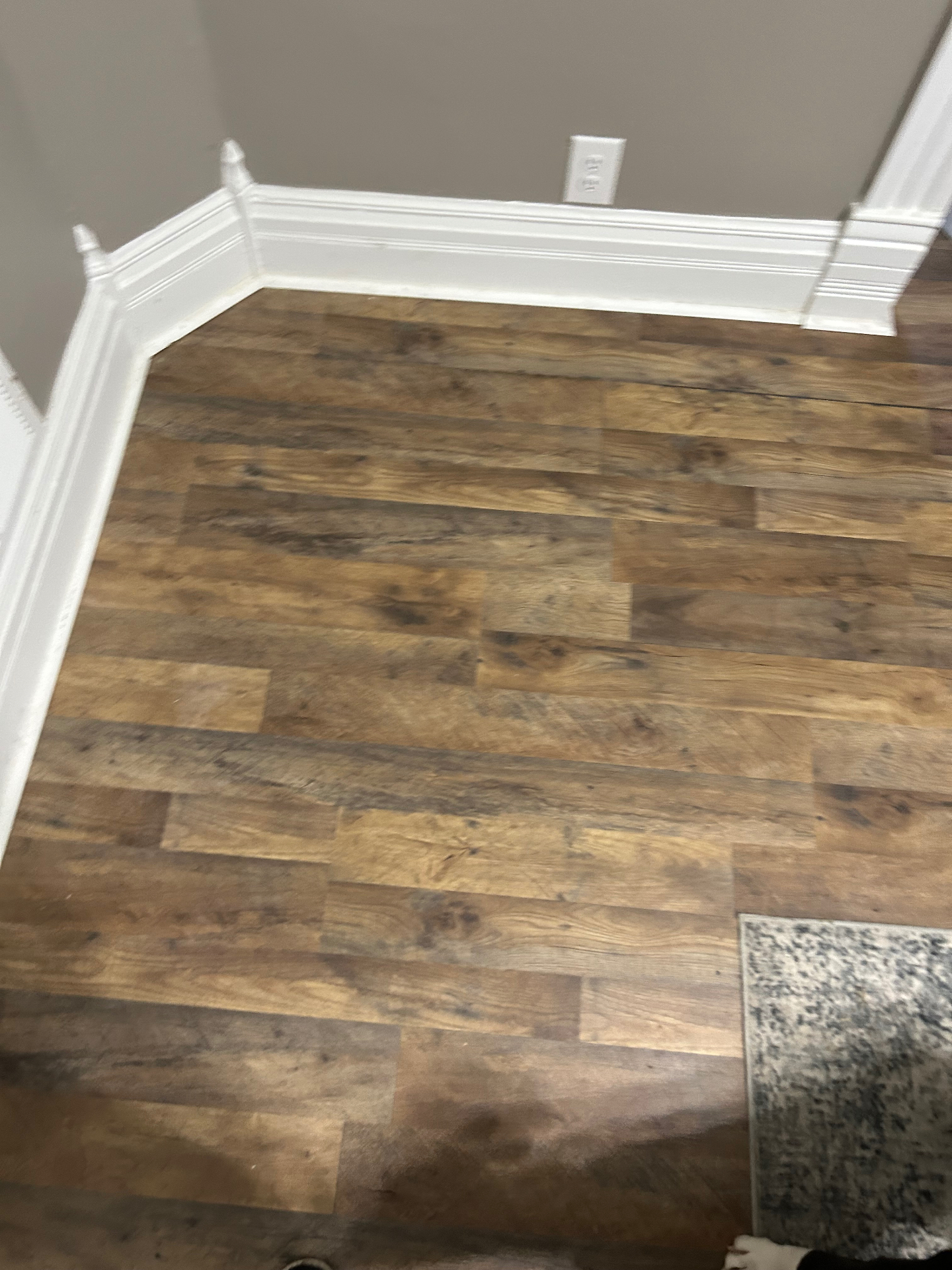 Vinyl Plank Floor & Trim — New plank flooring laid tight with fresh baseboard and corner blocks set.