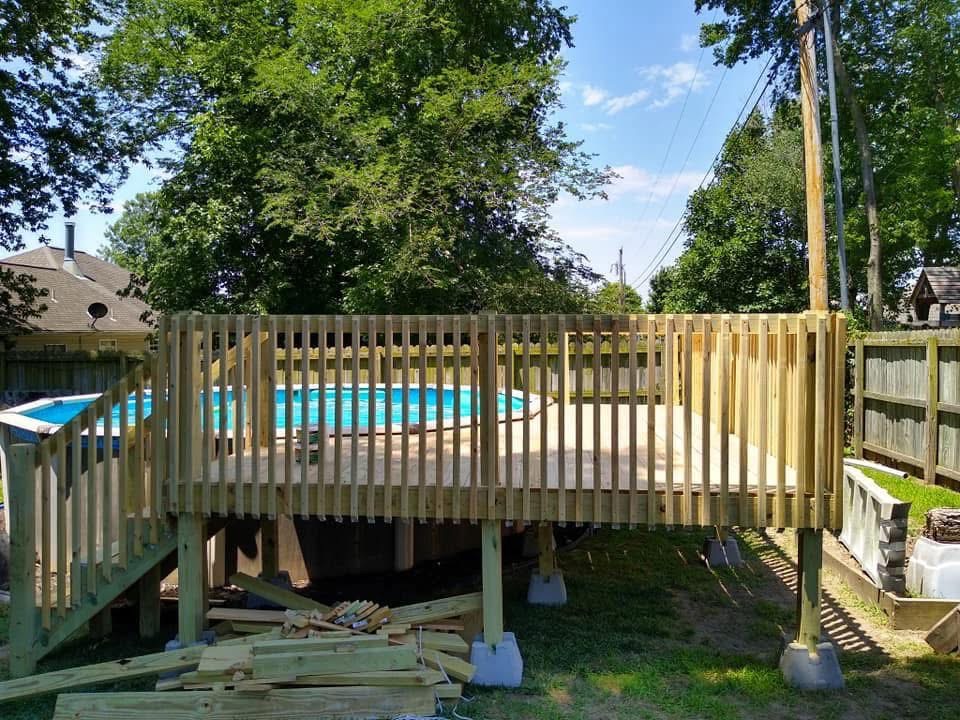 Pool Deck & Stairs — Raised pool deck with railing and stair access, built on site.